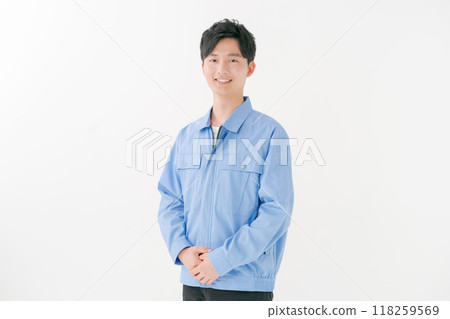 A young man wearing work clothes 118259569
