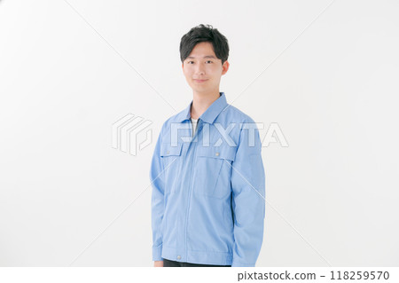 A young man wearing work clothes 118259570