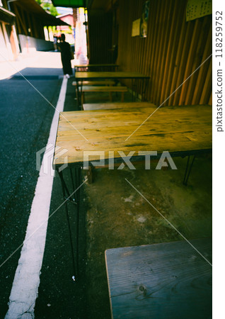 Old wooden table and quiet alley Old wooden table and quiet alley 118259752