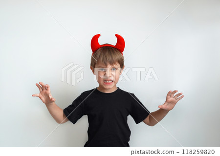 Halloween concept. cute little boy with red devil horns isolated on white background Halloween concept. cute little boy with red devil horns isolated on white background 118259820