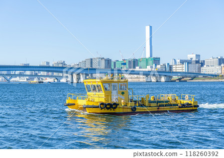 A cleaning ship cleaning Tokyo Bay and the Tokyo cityscape A cleaning ship cleaning Tokyo Bay and the Tokyo cityscape 118260392