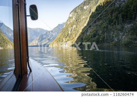 Look from a window of a boat sailing on an alpine lake with mountains around, Konigsee, Germany 118260474