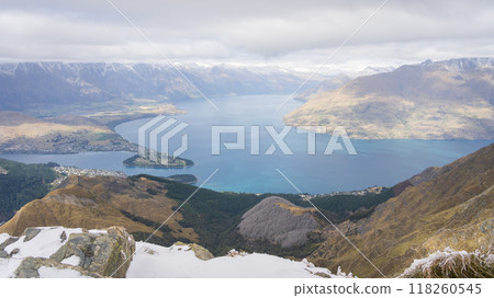 View on township, alpine lake and surrounding mountains from peak summit in New Zealand View on township, alpine lake and surrounding mountains from peak summit in New Zealand 118260545