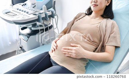 Pregnant woman undergoing ultrasound examination 118260768