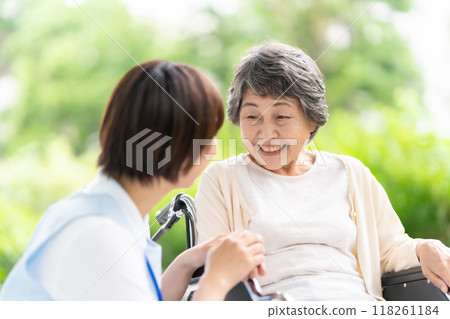 Wheelchair caregiver and senior woman 118261184