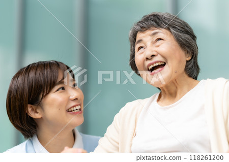 Wheelchair caregiver and senior woman 118261200