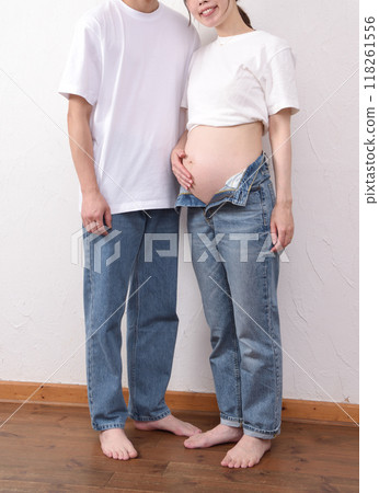 A young pregnant woman with a big belly and her husband A young pregnant woman with a big belly and her husband 118261556