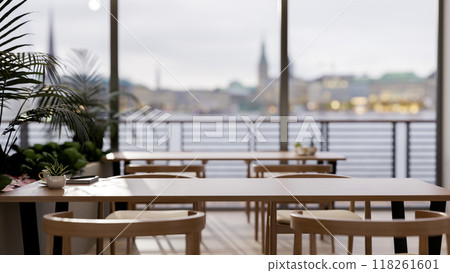 A wooden tabletop in a contemporary minimalist restaurant with a stunning city view. A wooden tabletop in a contemporary minimalist restaurant with a stunning city view. 118261601