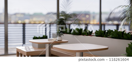 A wooden tabletop in a contemporary restaurant feature indoor garden and a stunning city view. A wooden tabletop in a contemporary restaurant feature indoor garden and a stunning city view. 118261604