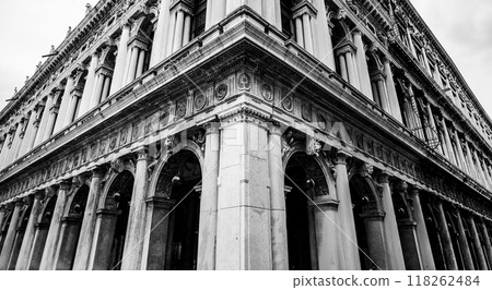 The striking architectural features of the New Procuracies at Saint Marc Square highlight Venetian craftsmanship, with elegant columns and intricate designs that showcase its historic charm. 118262484