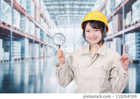 A woman in work clothes searching for inventory in a warehouse A woman in work clothes searching for inventory in a warehouse 118264109