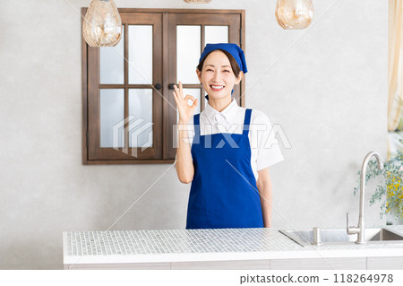 A woman working as a housekeeping service in an apron 118264978