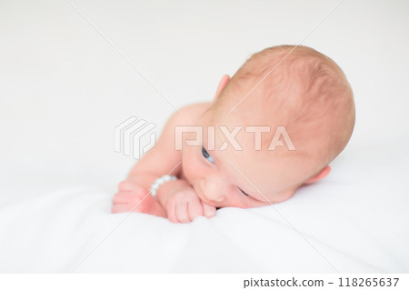 Little baby on white bed 118265637