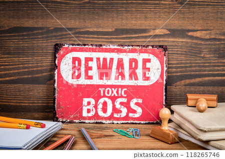 Toxic Boss. Beware sign with text on a wooden texture office table 118265746