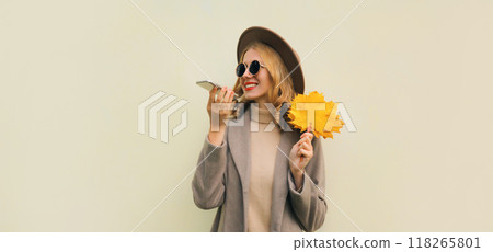 Autumn portrait of happy smiling young woman calling on phone, stylish girl talking on a smartphone Autumn portrait of happy smiling young woman calling on phone, stylish girl talking on a smartphone 118265801