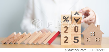 block falling on 2025 year and percentage UP and Down arrow with Home model. Real estate Mortgage, Refinance, House loan and debt, Interest rate, Insurance, Financial Property and economic recession block falling on 2025 year and percentage UP and Down arrow with Home model. Real estate Mortgage, Refinance, House loan and debt, Interest rate, Insurance, Financial Property and economic recession 118265999
