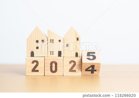 2024 end year to Happy New Year 2025 with house model. real estate, Home loan and mortgage, tax, investment, financial, savings and New Year Resolution concepts 118266020