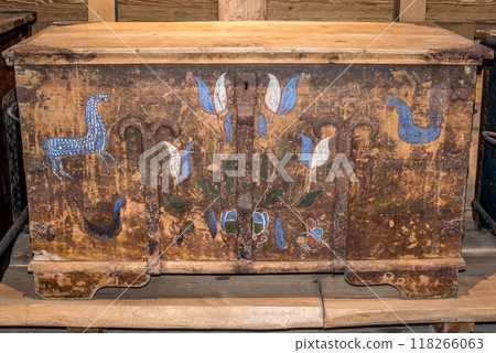 Old wooden chest against wooden wall 118266063