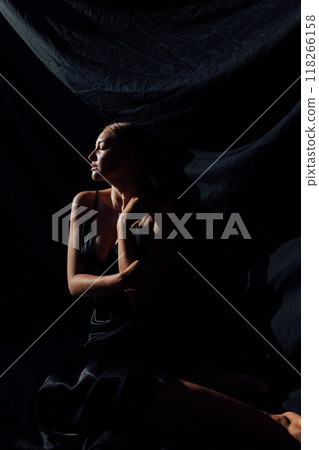 Beautiful slim fashion woman in black silk dress 118266158