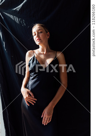 Beautiful slim fashion woman in black silk dress 118266160