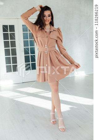 Beautiful slim fashion woman in summer light dress in white room Beautiful slim fashion woman in summer light dress in white room 118266219