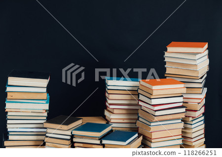 lots of stacks of old vintage books to study in the library on a black background 118266251