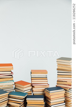 lots of old stacks of educational books on a white background of the library 118266252