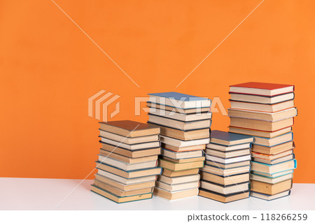 Old vintage stacks of books to read on an orange background Old vintage stacks of books to read on an orange background 118266259