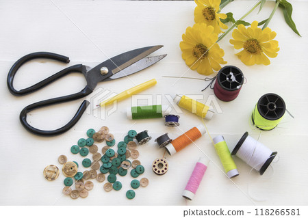 scissors, thread, button for sewing of lifestyle arrangement flat lay style 118266581