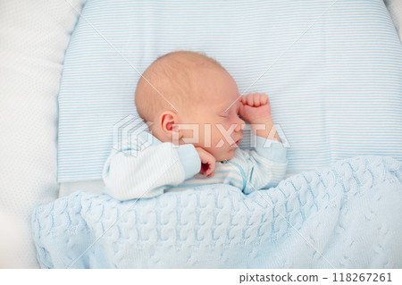 Newborn baby boy in white bassinet 118267261
