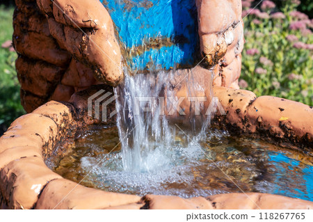 A detailed close up image of a fountain with water flowing out of it A detailed close up image of a fountain with water flowing out of it 118267765