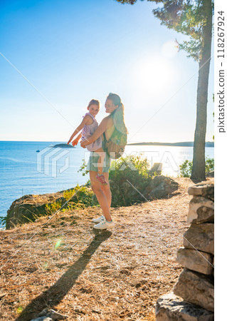 Mother and daughter in shore in the bay of Uvala Gradina near the town of Vela Luka on the island of Korcula in Croatia 118267924