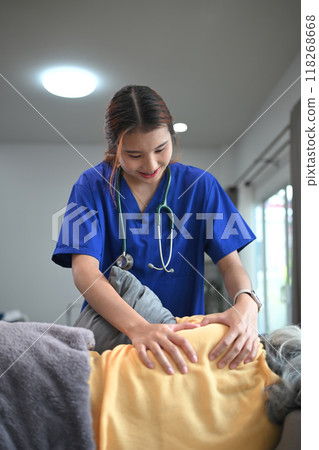 Female manual therapist massaging shoulder blades of senior patient. Physical therapy and rehabilitation concept 118268668
