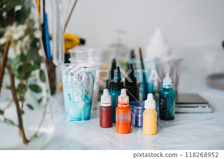 Creating vibrant epoxy resin art with various pigments and tools in a DIY workspace 118268952