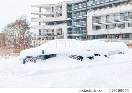 Poland, Krakow, 12.03.2023, snowfall, snowy street with cars after a blizzard 118269663