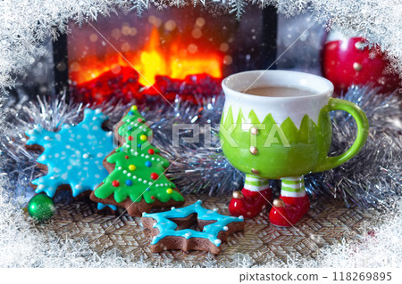 gingerbread cookies and a cup of hot chocolate. A view through a snowy window gingerbread cookies and a cup of hot chocolate. A view through a snowy window 118269895