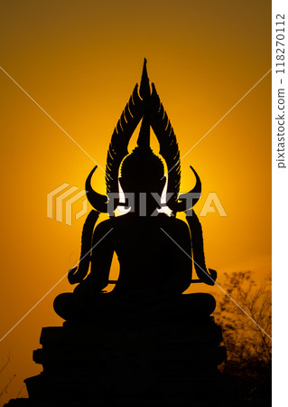 Silhouette Buddha statue between creating and building process, at outdoor field with the sun set and twilight period time., Thailand. 118270112