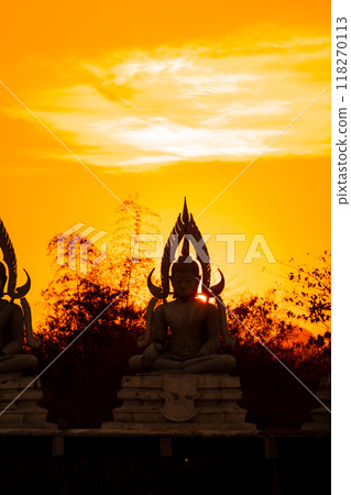 Silhouette Buddha statue between creating and building process, at outdoor field with the sun set and twilight period time., Thailand. 118270113