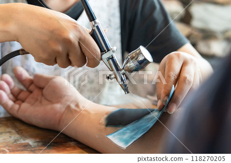 The modern alternative for someone who wants tattoo art on their skin but doesn't want to get wounded by a needle or go through the tattoo process is an air brush tattoo. 118270205