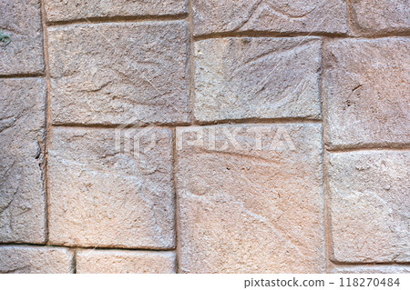 The stone wall is patterned in light brown tones, each cube is different, small and large alternately. The stone wall is patterned in light brown tones, each cube is different, small and large alternately. 118270484