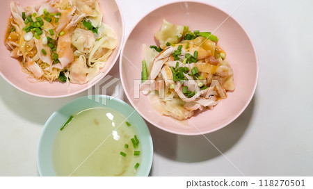 Two bowls of shrimp wonton noodles and a bowl of soup were placed on the table. Two bowls of shrimp wonton noodles and a bowl of soup were placed on the table. 118270501