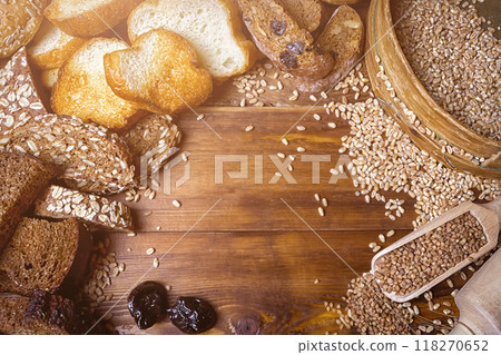 Assortment of baked bread on wooden table background 118270652