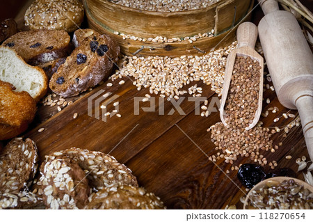 Assortment of baked bread on wooden table background 118270654