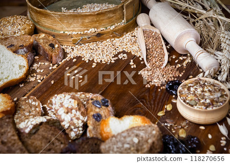 Assortment of baked bread on wooden table background Assortment of baked bread on wooden table background 118270656