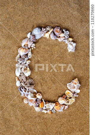 The letter C of the English alphabet, a letter made of seashells on the sand. The letter C of the English alphabet, a letter made of seashells on the sand. 118270660