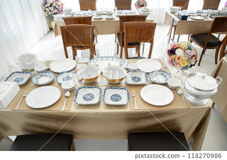 Elegant white ceramic crockery, expertly placed on the table, sets the stage for a memorable meal. Elegant white ceramic crockery, expertly placed on the table, sets the stage for a memorable meal. 118270986