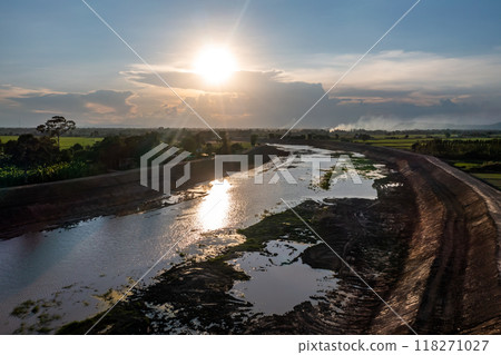 Construction dredges up for a canal and dam, to prevent a flood in the rainy season. Date on 14 May 2021 at Uthai Thani province, Thailand. 118271027