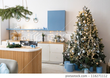 Interior light grey kitchen and red christmas decor. Preparing lunch at home on the kitchen concept. Focus on tree Interior light grey kitchen and red christmas decor. Preparing lunch at home on the kitchen concept. Focus on tree 118271112