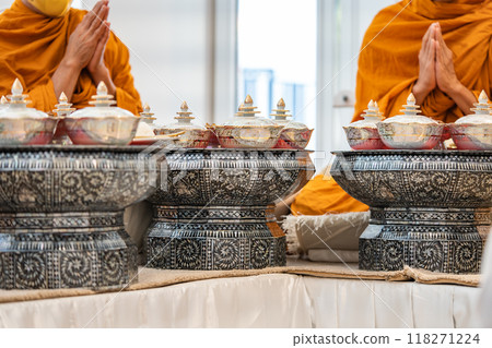 Thai bowl set arranged with rice, dishes on the small thai wooden table, symbolizing respect for Buddhist monks during morning ceremonies. 118271224