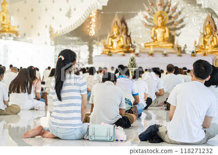Portrait of people are meditating on Buddhist practices in the temple. People sit for meditation with peace and relax at temple or church and wearing white clothes. Portrait of people are meditating on Buddhist practices in the temple. People sit for meditation with peace and relax at temple or church and wearing white clothes. 118271232